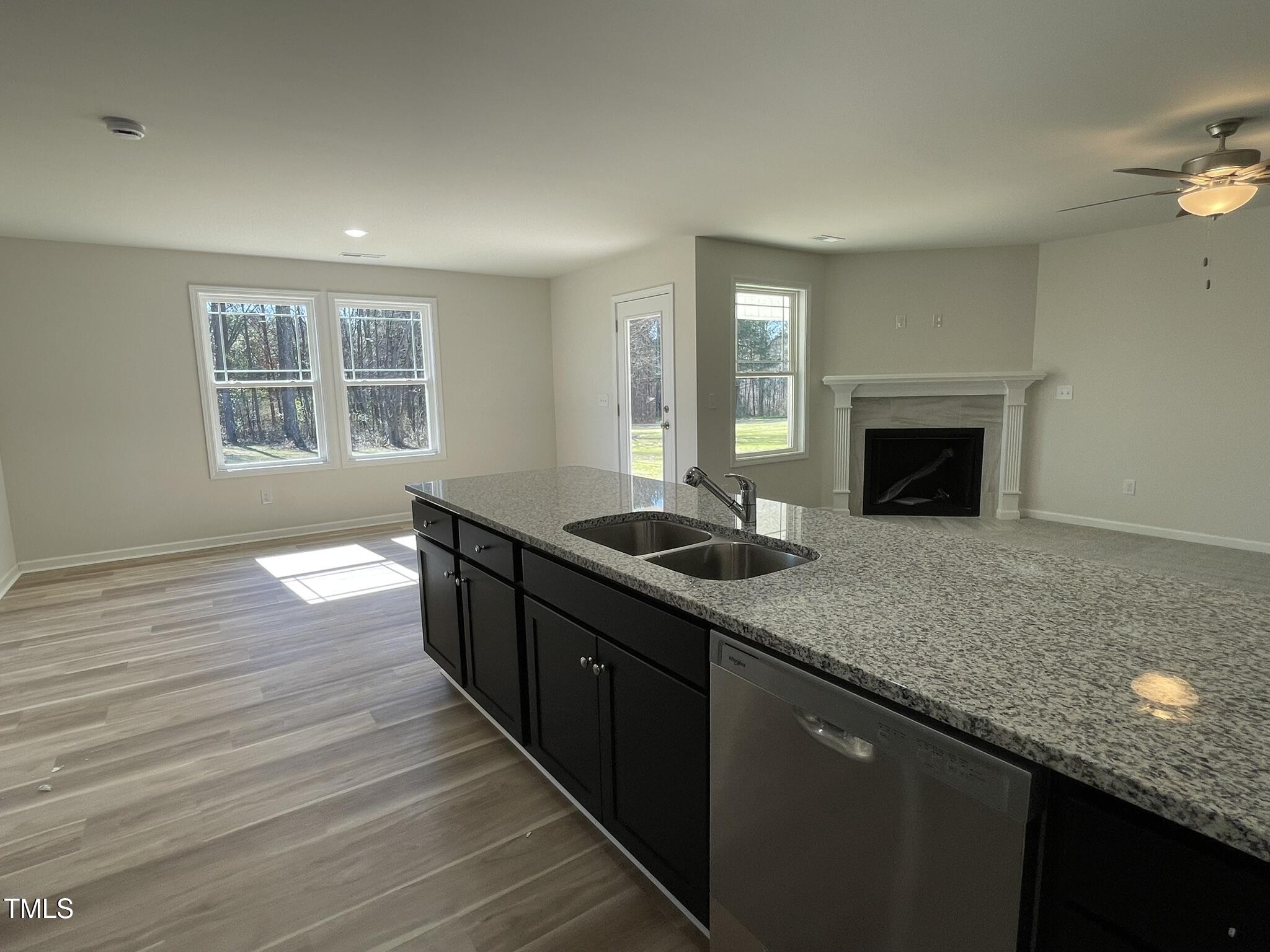 111 Magnolia Run Way Benson, NC 27504 - Photo 4 of 18 a kitchen with stainless steel appliances granite countertop a sink stove and cabinets