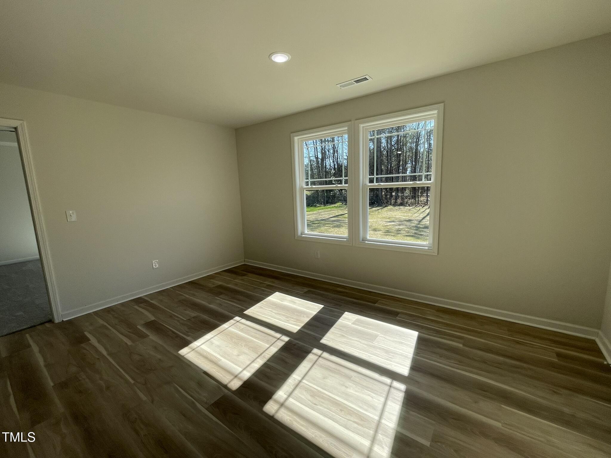 111 Magnolia Run Way Benson, NC 27504 - Photo 8 of 18 a view of an empty room and window