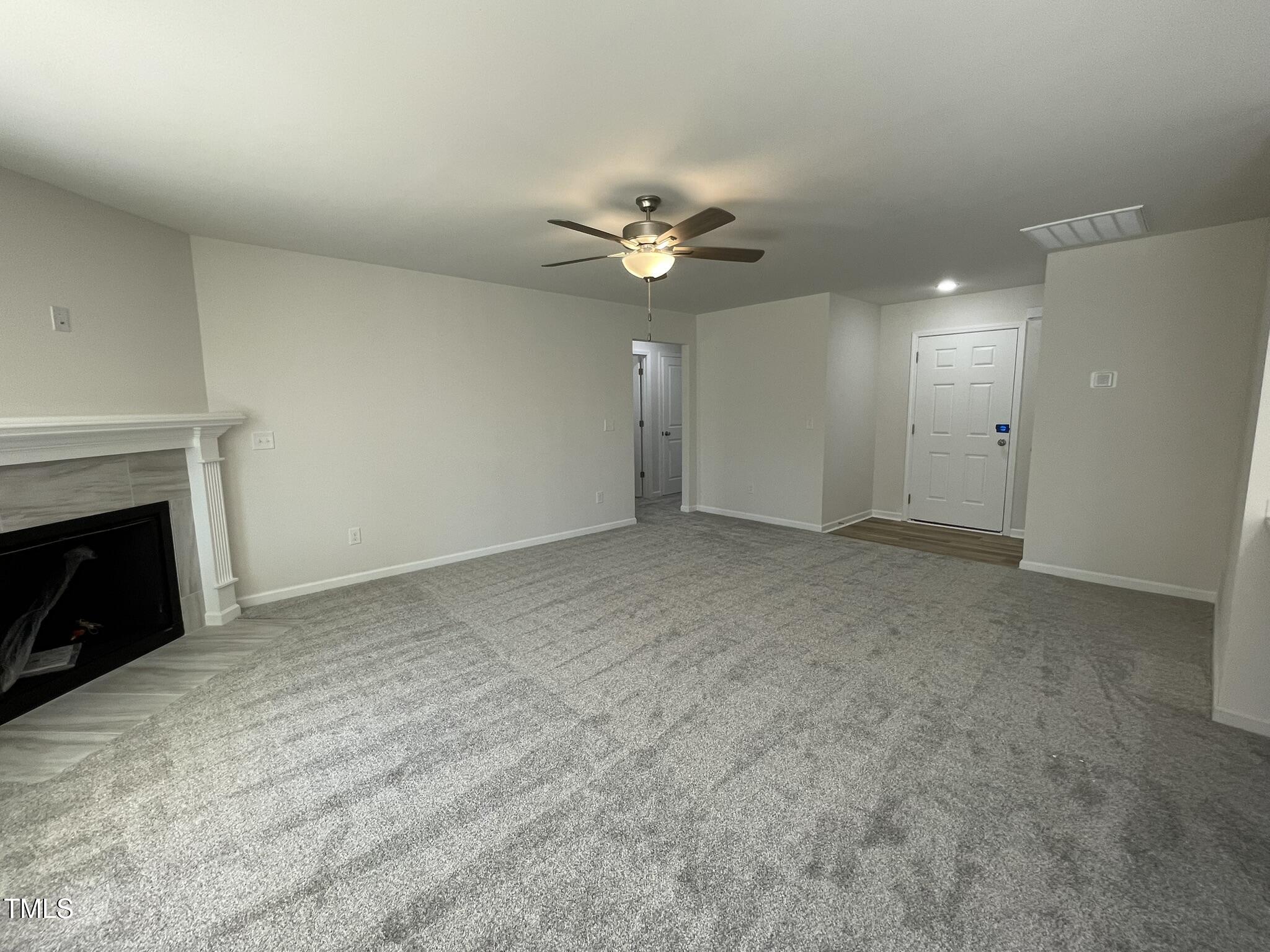 111 Magnolia Run Way Benson, NC 27504 - Photo 9 of 18 a view of an empty room with a fireplace