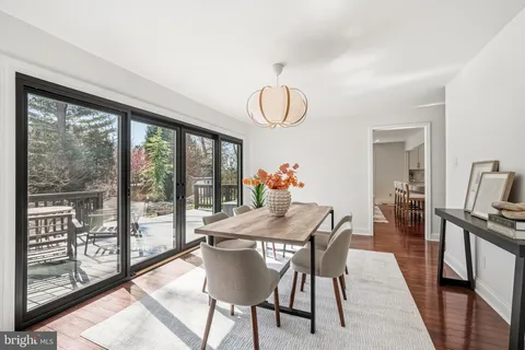 a living room with furniture a fireplace and a floor to ceiling window
