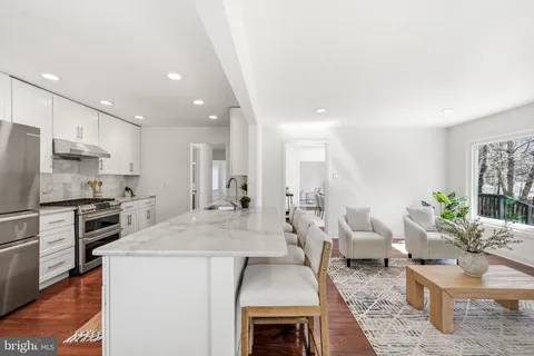 a kitchen with sink a stove and cabinets