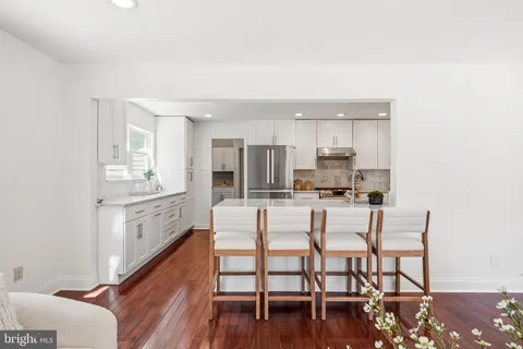 a kitchen with granite countertop a sink stainless steel appliances and cabinets