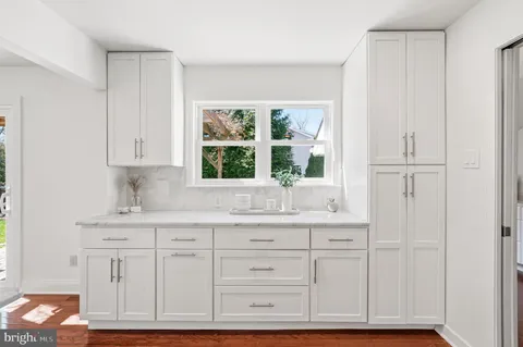 an empty room with a window and wooden floor