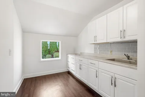 a bathroom with a sink vanity and a mirror