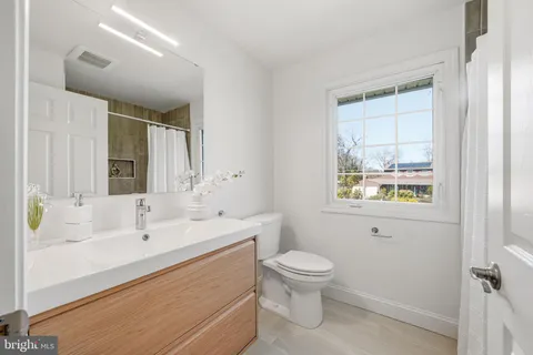 a bathroom with a sink mirror and vanity