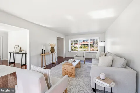 a dining room with furniture a rug and wooden floor
