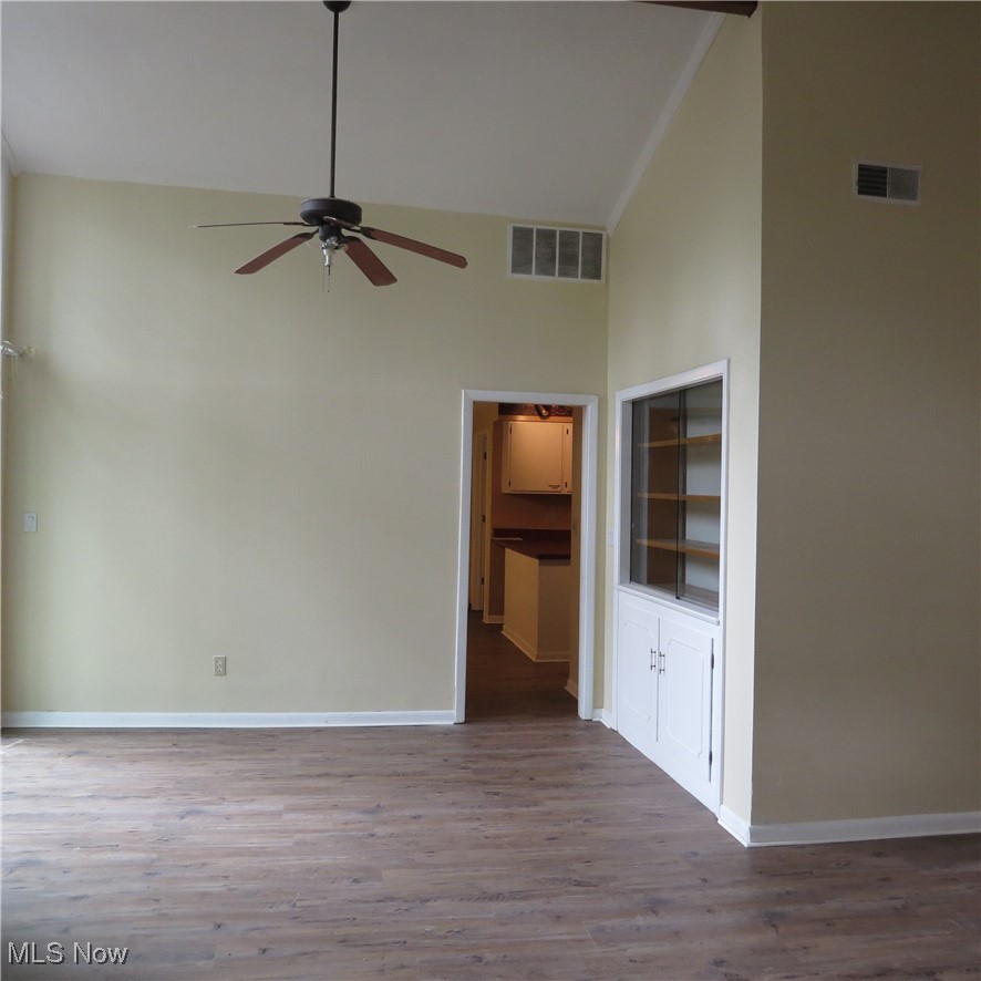 430 High Meadow Road Amherst, OH 44001 - Photo 11 of 29 Spare room featuring ceiling fan, hardwood / wood-style floors, and high vaulted ceiling