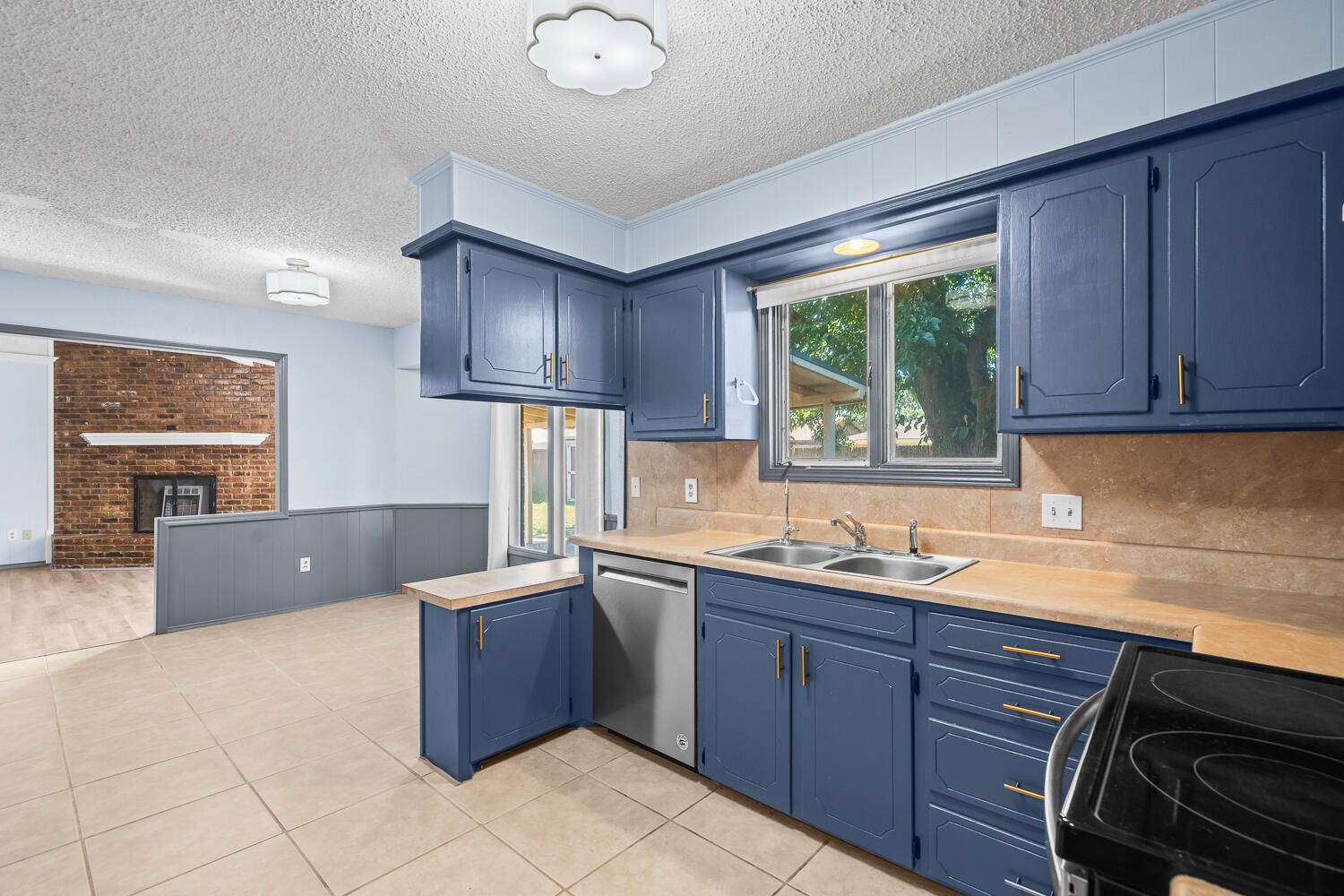 4809 72nd Street Lubbock, TX 79424 - Photo 12 of 34 a kitchen with a sink window and cabinets