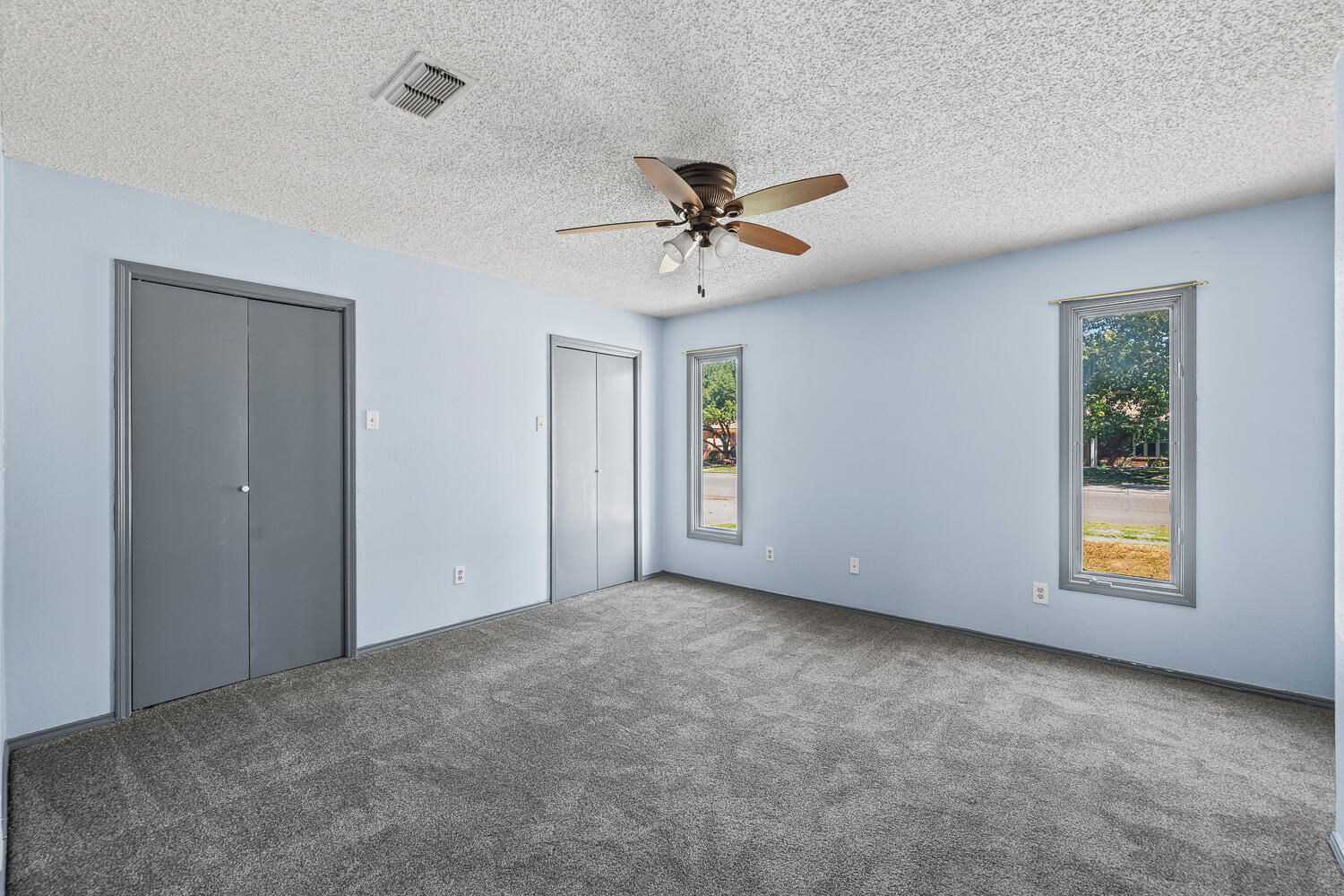 4809 72nd Street Lubbock, TX 79424 - Photo 16 of 34 an empty room with windows and fan