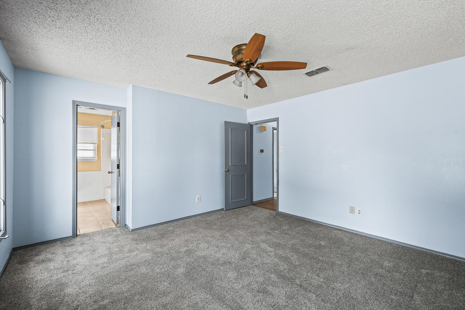 4809 72nd Street Lubbock, TX 79424 - Photo 18 of 34 a view of a room with a ceiling fan and window