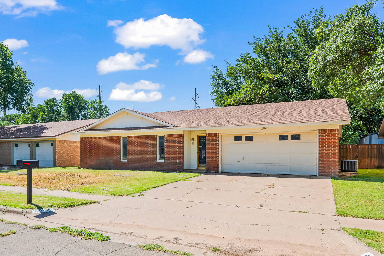 4809 72nd Street Lubbock, TX 79424 - Photo 2 of 34 a front view of a house with a garden and yard