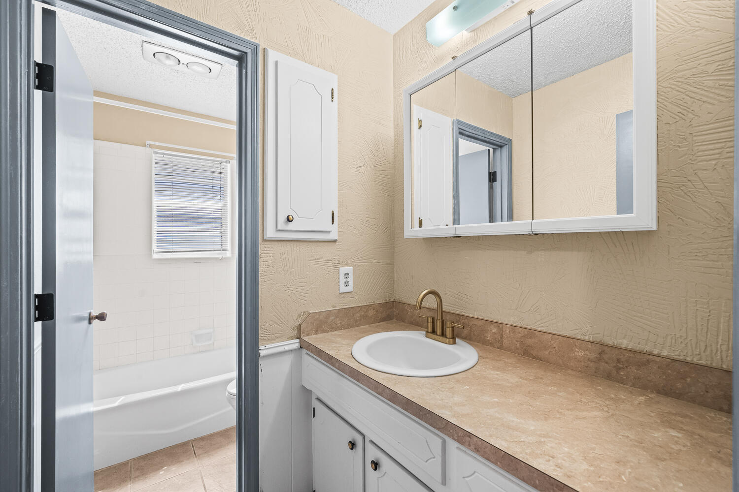 4809 72nd Street Lubbock, TX 79424 - Photo 24 of 34 a bathroom with a sink and a mirror