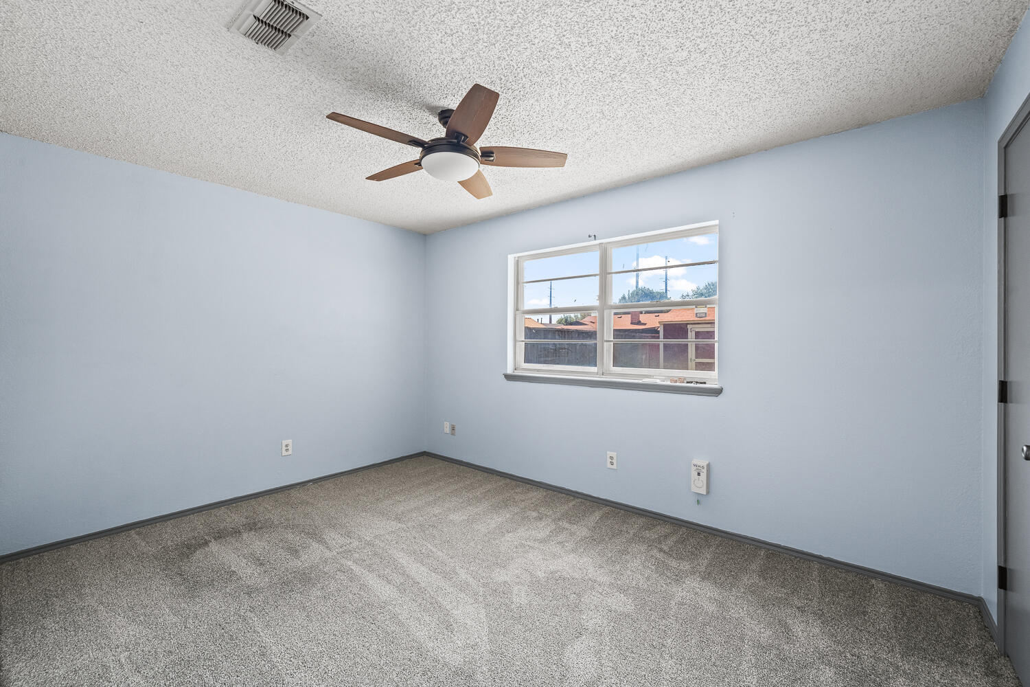 4809 72nd Street Lubbock, TX 79424 - Photo 26 of 34 an empty room with a window and a fan