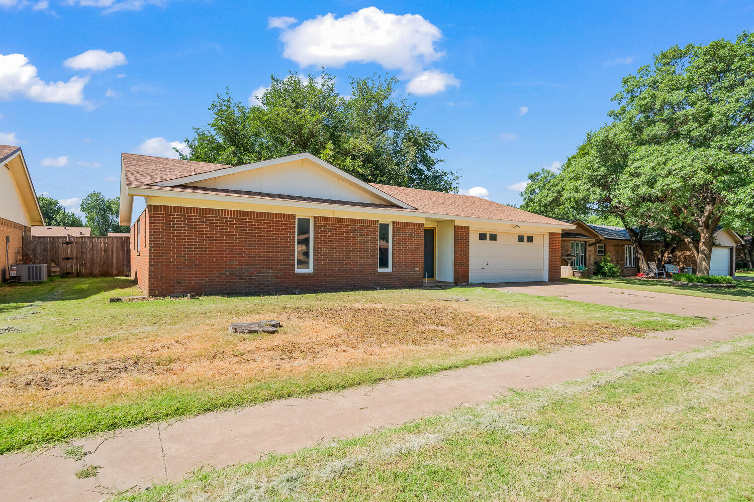 4809 72nd Street Lubbock, TX 79424 - Photo 3 of 34 a front view of a house with a yard and garage