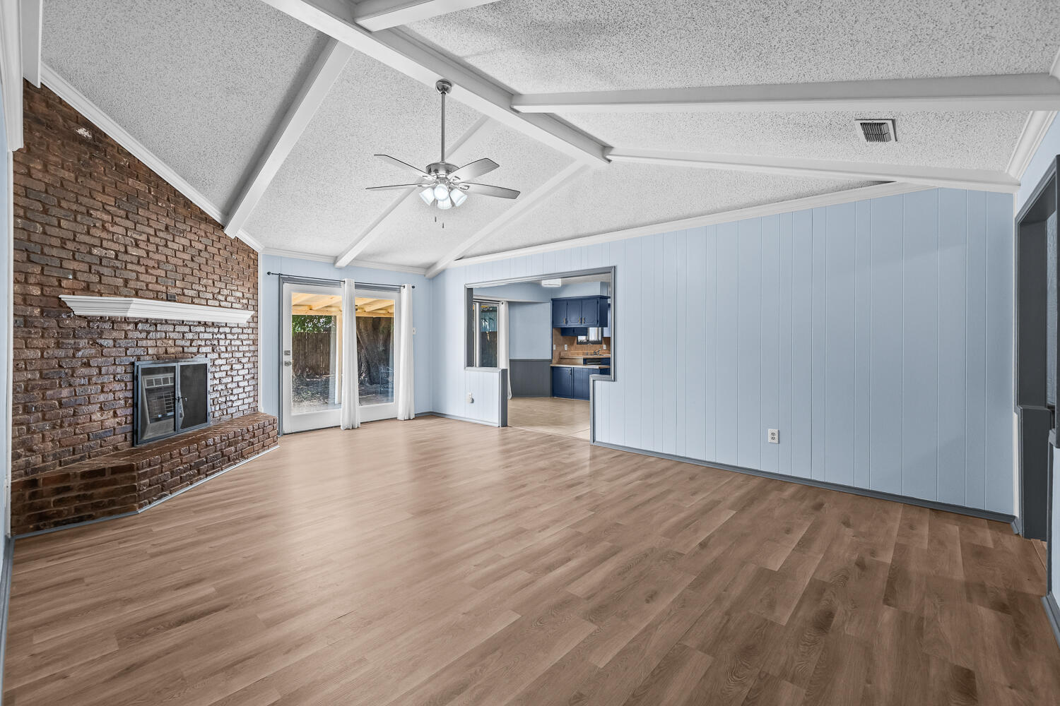 4809 72nd Street Lubbock, TX 79424 - Photo 4 of 34 a view of empty room with wooden floor and fireplace