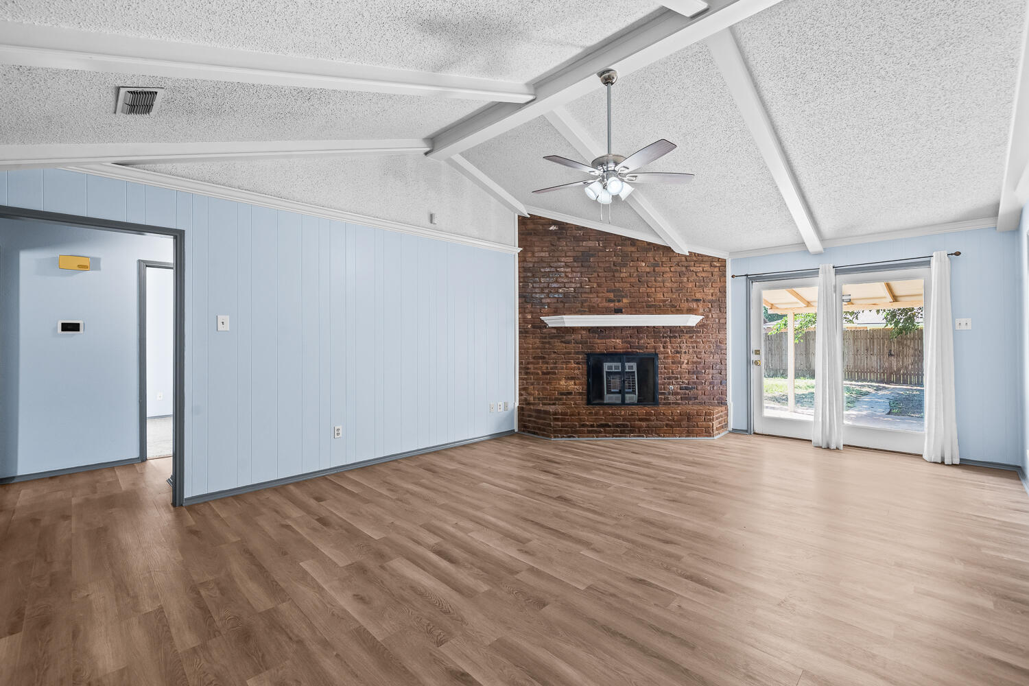 4809 72nd Street Lubbock, TX 79424 - Photo 5 of 34 a view of empty room with wooden floor and fireplace