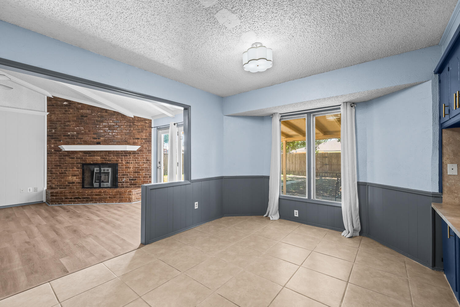 4809 72nd Street Lubbock, TX 79424 - Photo 10 of 34 an empty room with windows cabinet and fireplace