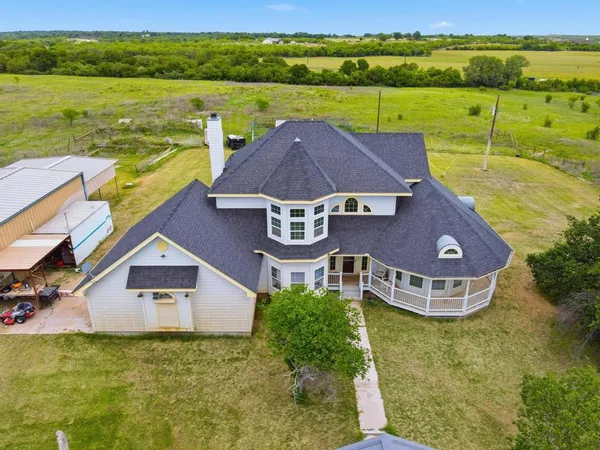 an aerial view of a house with a ocean view