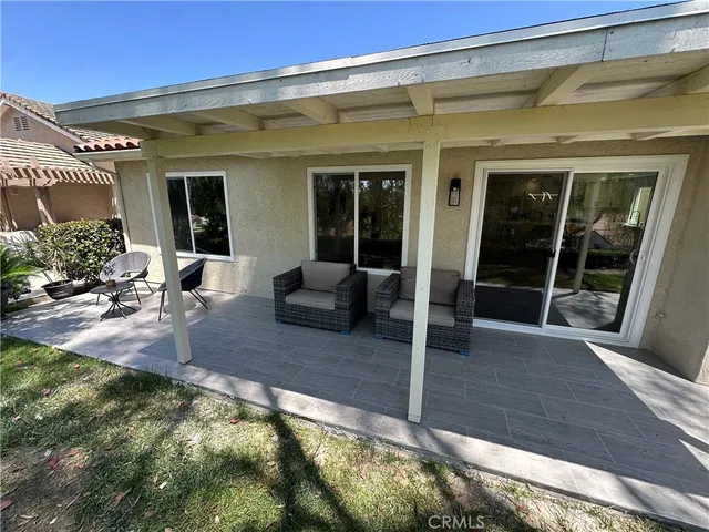 a view of swimming pool with outdoor seating and a garden