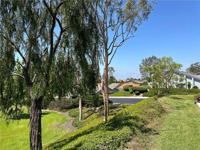 a front view of a multi story residential apartment building with yard