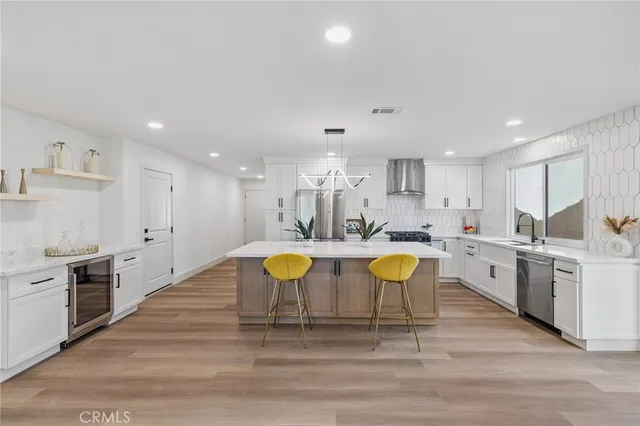 a large kitchen with lots of counter space and stainless steel appliances