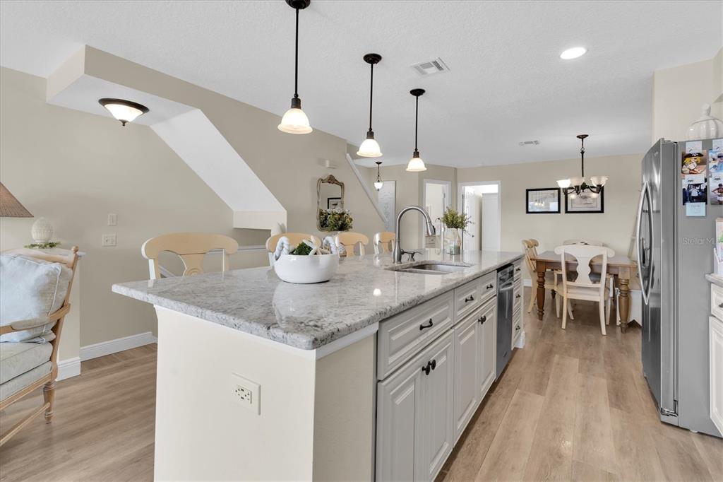 641 Garland Circle Indian Rocks Beach, FL 33785 - Photo 14 of 50 a large kitchen with kitchen island a island a sink stainless steel appliances and cabinets
