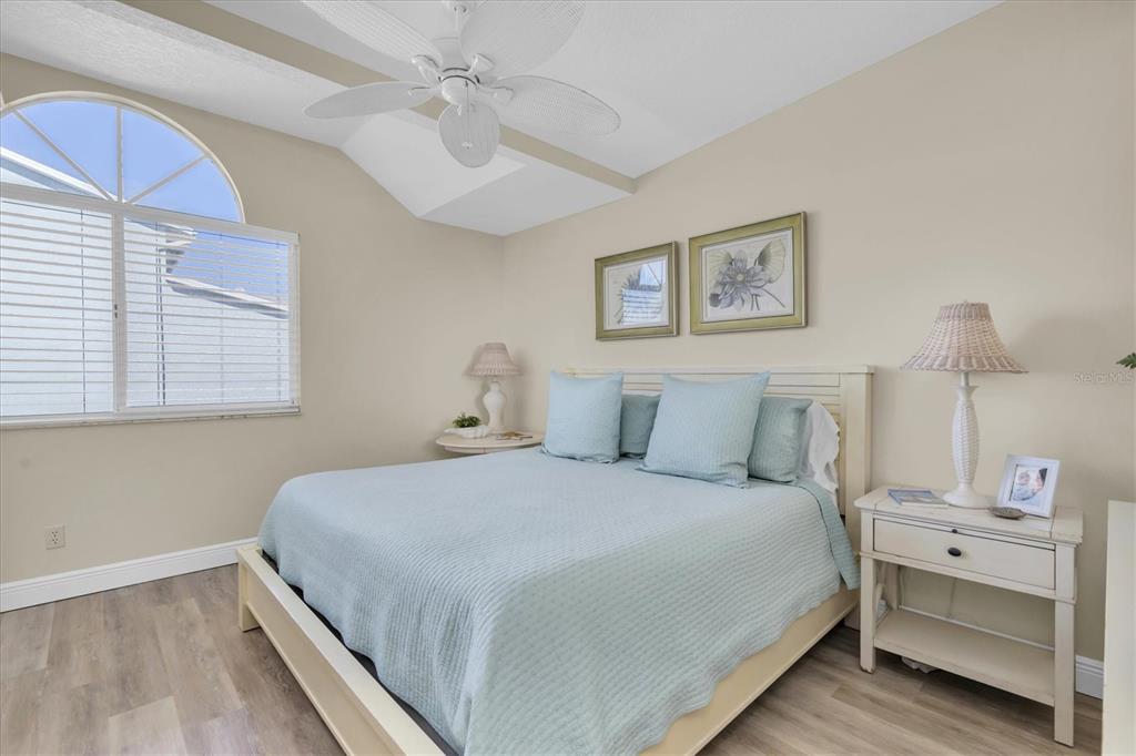 641 Garland Circle Indian Rocks Beach, FL 33785 - Photo 17 of 50 a bedroom with a bed and a night stand