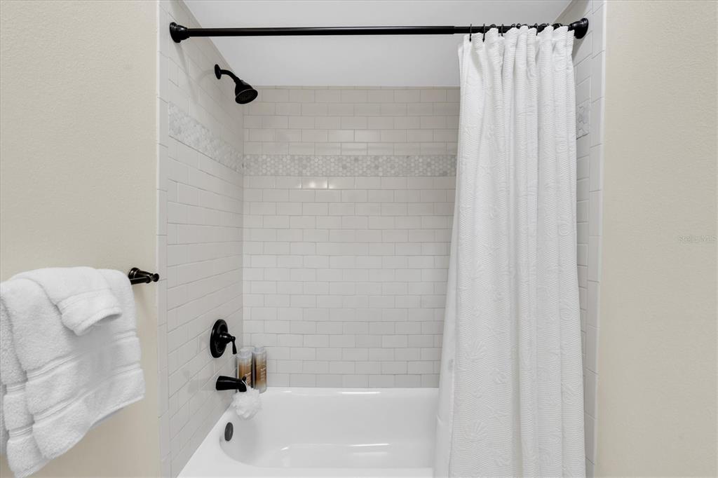 641 Garland Circle Indian Rocks Beach, FL 33785 - Photo 24 of 50 a bathroom with a shower and a bath tub