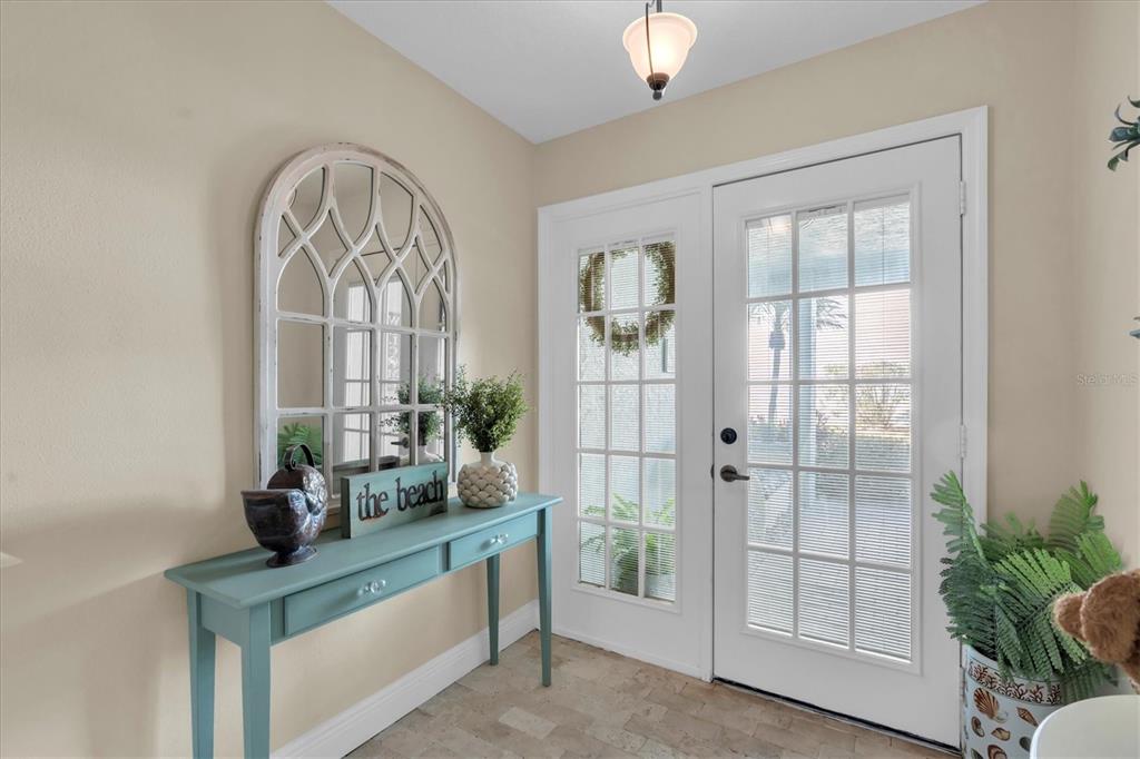 641 Garland Circle Indian Rocks Beach, FL 33785 - Photo 6 of 50 a living room with a large window and chandelier