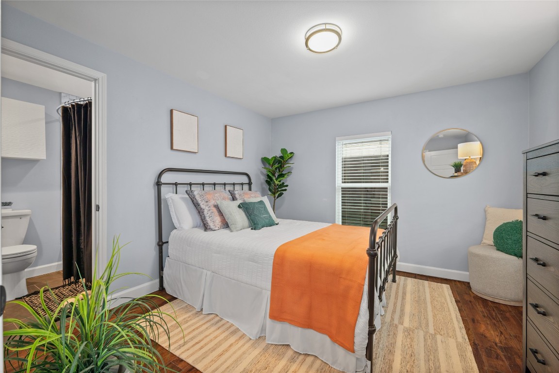 1191 Chicon Street Austin, TX 78702 - Photo 17 of 33 Primary bedroom featuring dark wood-type flooring and ensuite bathroom