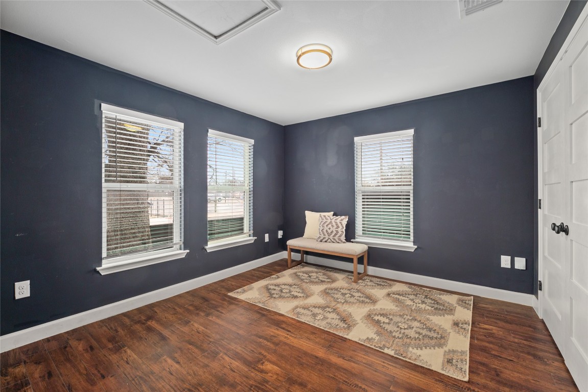 1191 Chicon Street Austin, TX 78702 - Photo 19 of 33 Secondary bedroom with plenty of natural light, dark wood-style flooring, and a baseboard heating unit