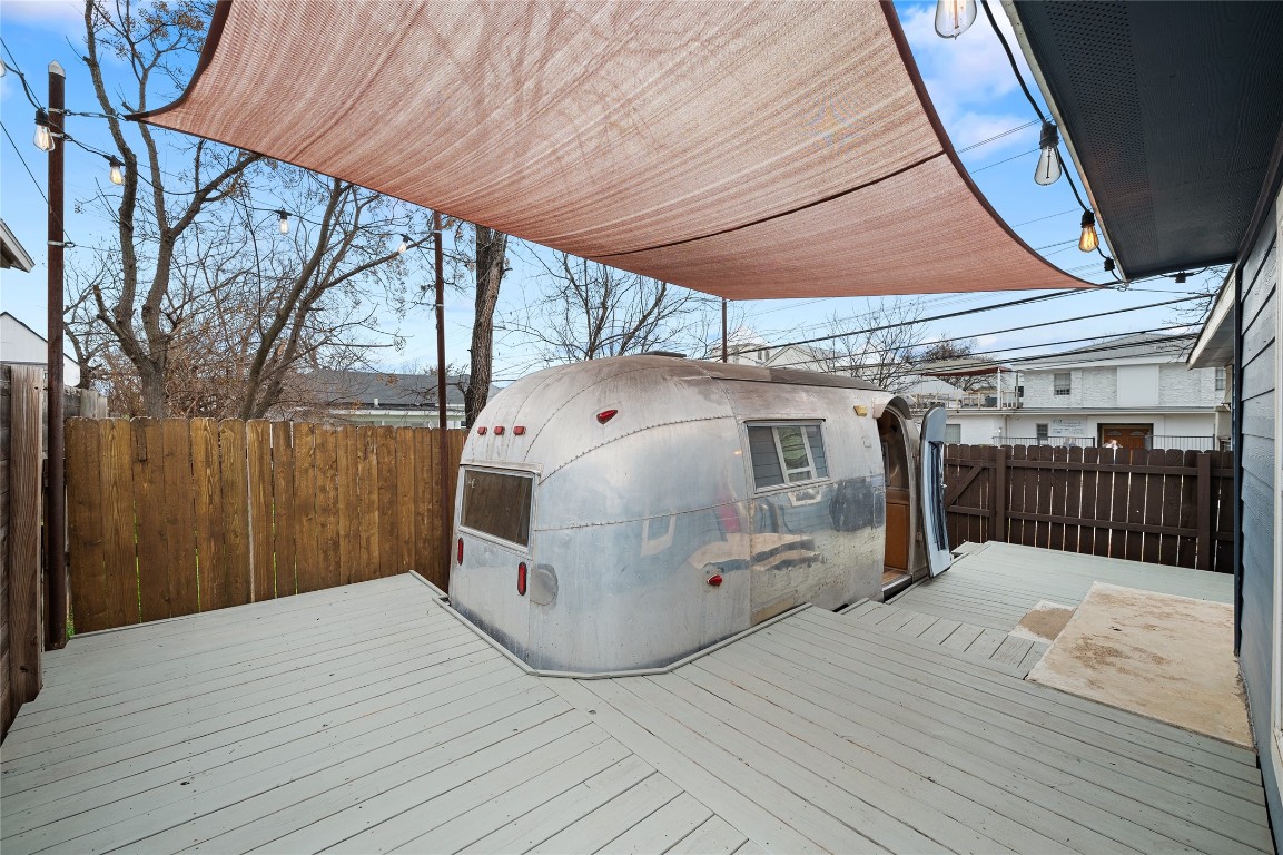 1191 Chicon Street Austin, TX 78702 - Photo 21 of 33 Shaded deck, perfect for outdoor meals or relaxation. Scout the retro charm of the 1963 Globe Trotter Airstream, which doubles as an additional living or entertaining space.
