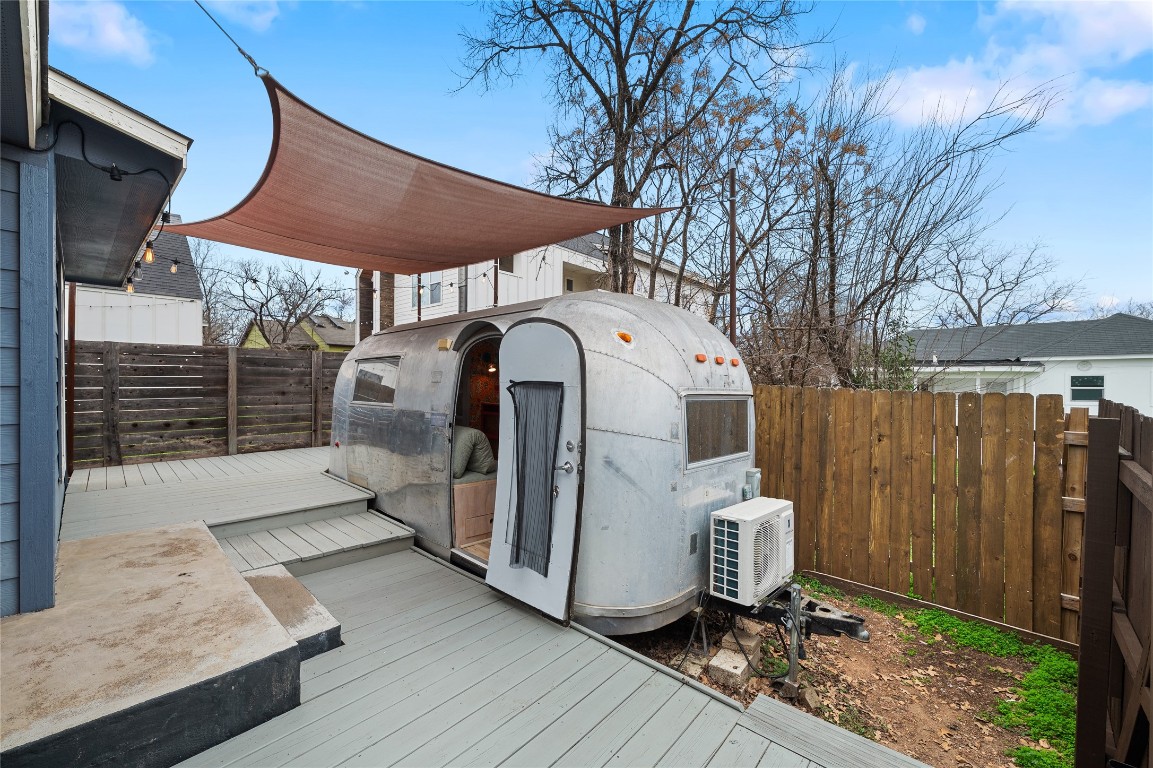 1191 Chicon Street Austin, TX 78702 - Photo 22 of 33 Shaded deck, perfect for outdoor meals or relaxation. Scout the retro charm of the 1963 Globe Trotter Airstream, which doubles as an additional living or entertaining space.