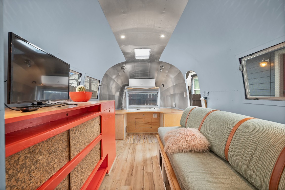 1191 Chicon Street Austin, TX 78702 - Photo 24 of 33 Inside the Airstream, you'll find a thoughtfully designed interior featuring cozy seating, built-in storage, and ample counter space—perfect for an office, guest quarters, or lounge. Don’t miss how light and modern finishes make the space feel surprisingly spacious.