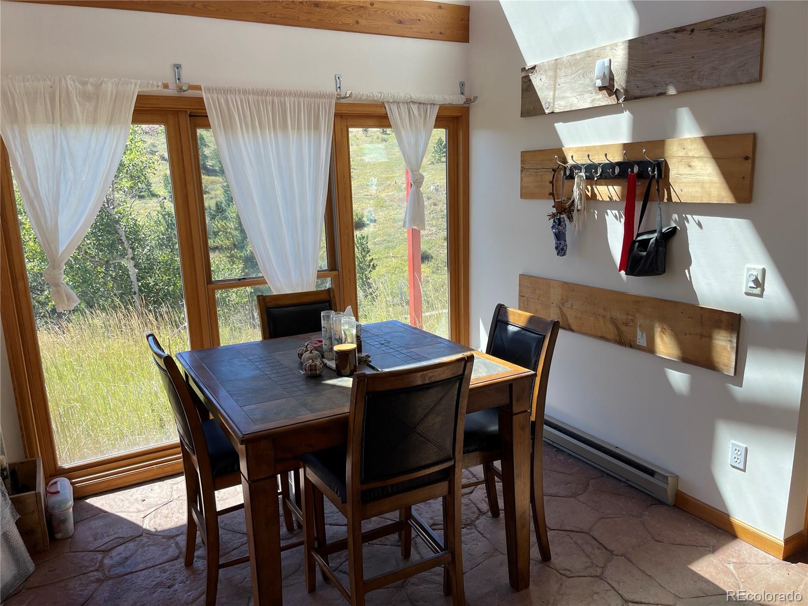 408 Lost Angel Road Boulder, CO 80302 - Photo 2 of 8 a view of a dining room with furniture and window