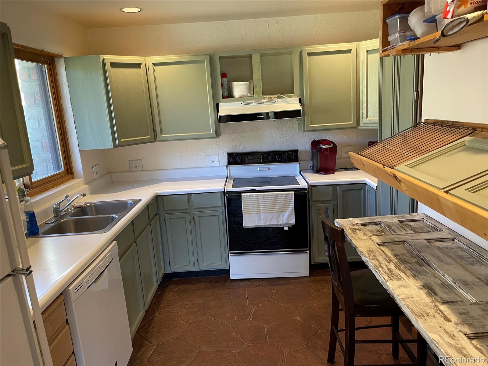 408 Lost Angel Road Boulder, CO 80302 - Photo 4 of 8 a kitchen with a sink stove and cabinets
