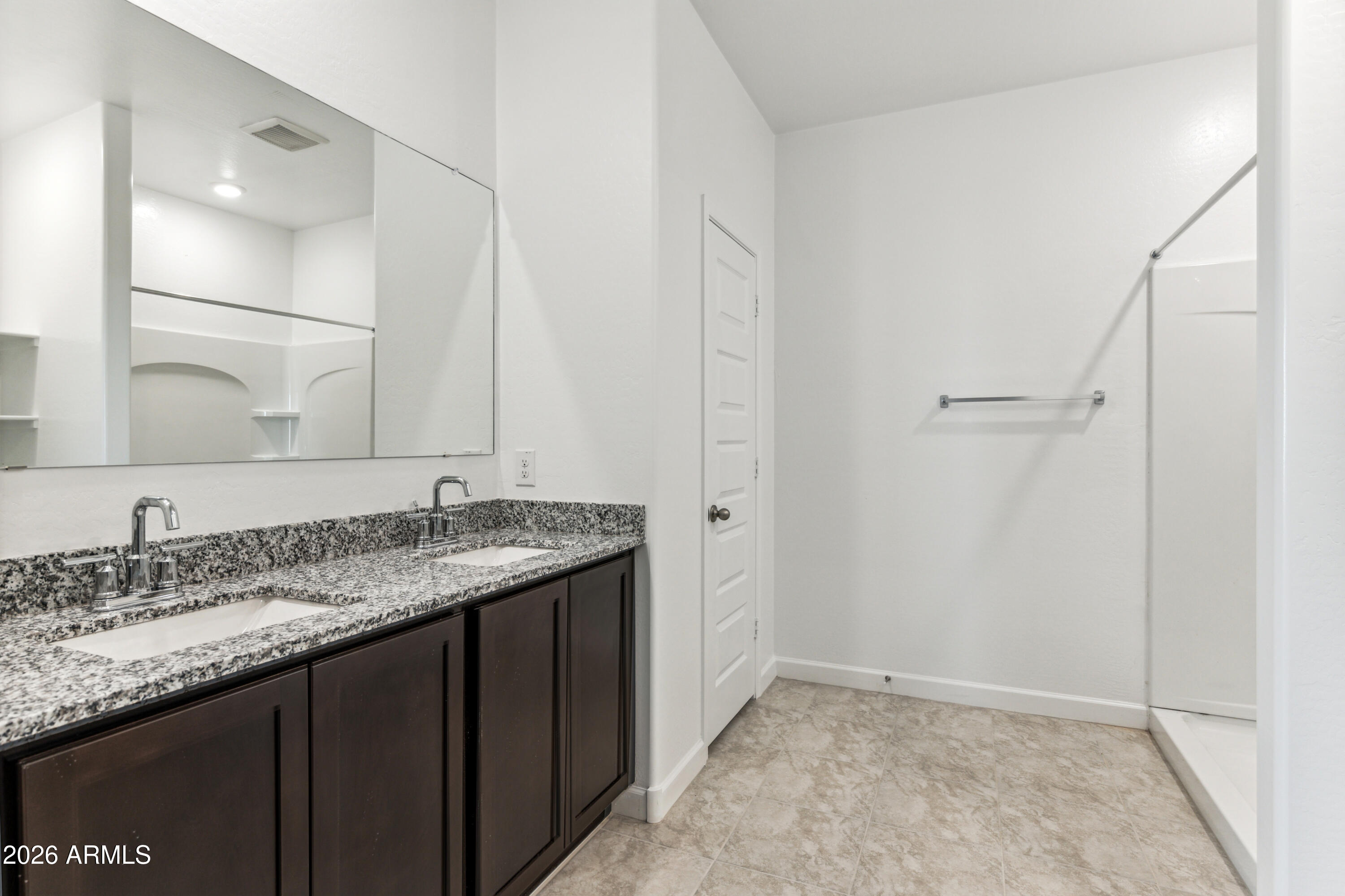 17885 North Ravello Road Maricopa, AZ 85138 - Photo 13 of 35 a bathroom with a granite countertop sink and a mirror