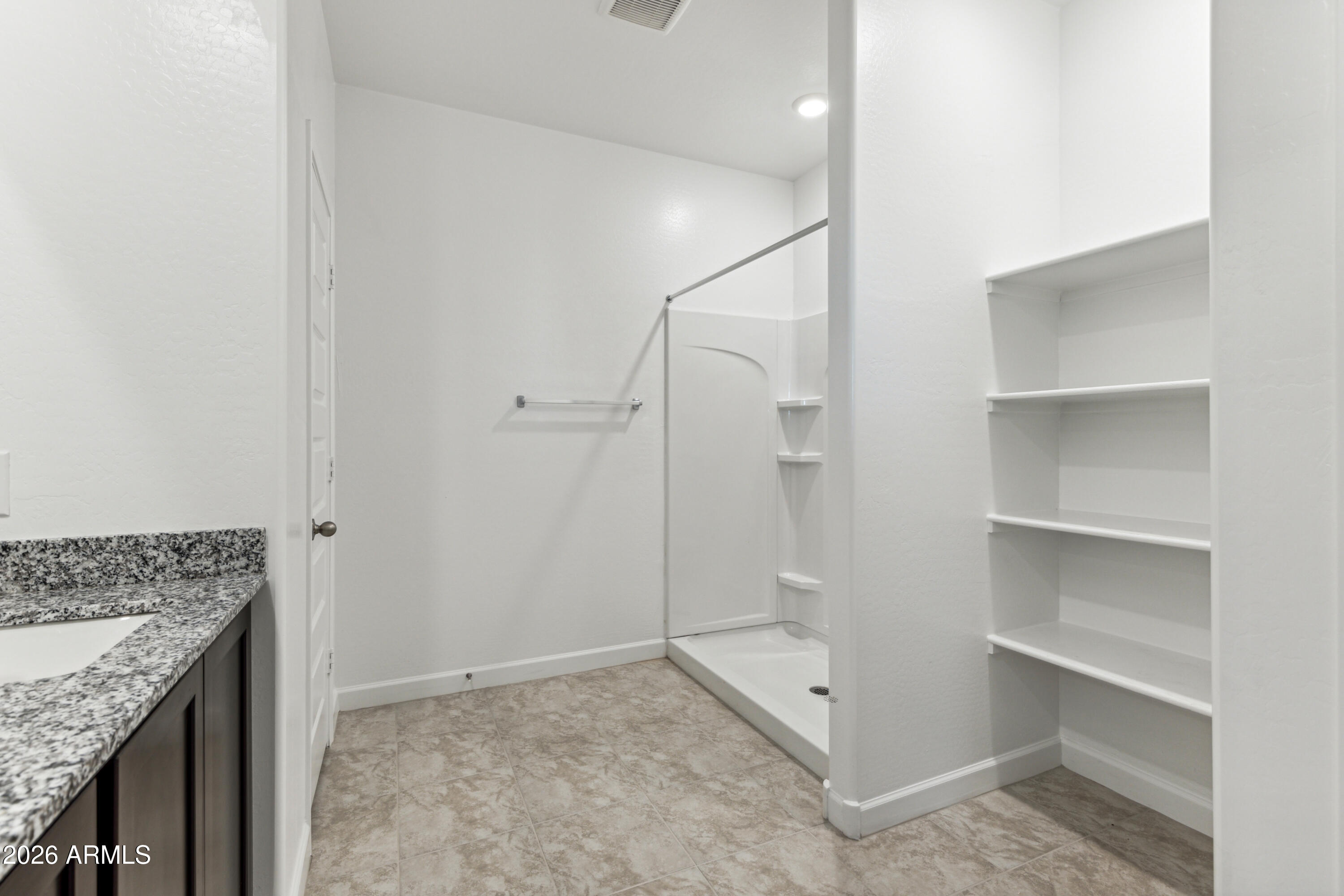 17885 North Ravello Road Maricopa, AZ 85138 - Photo 14 of 35 a bathroom with a granite countertop sink and shower