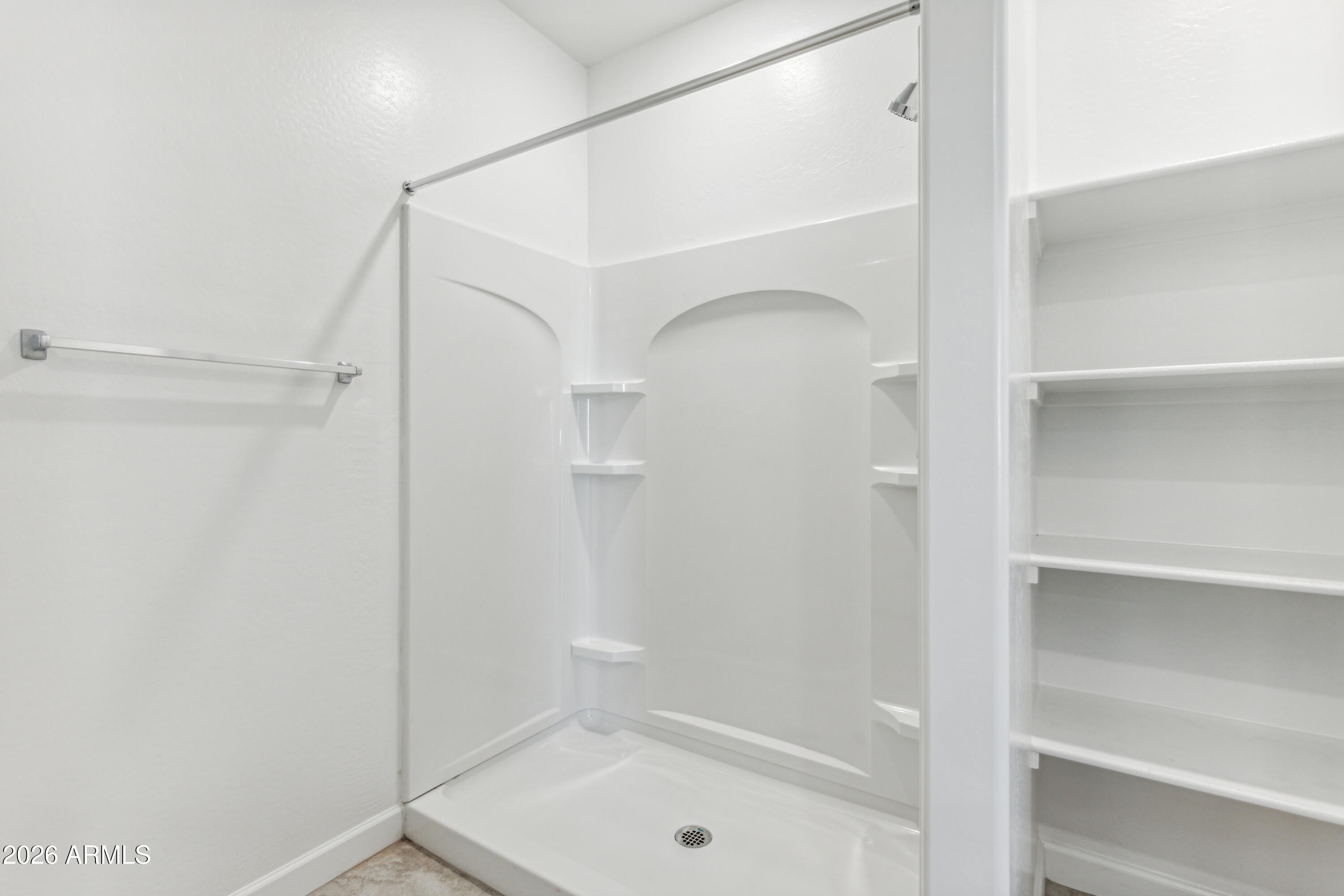 17885 North Ravello Road Maricopa, AZ 85138 - Photo 15 of 35 a bathroom with a glass shower door