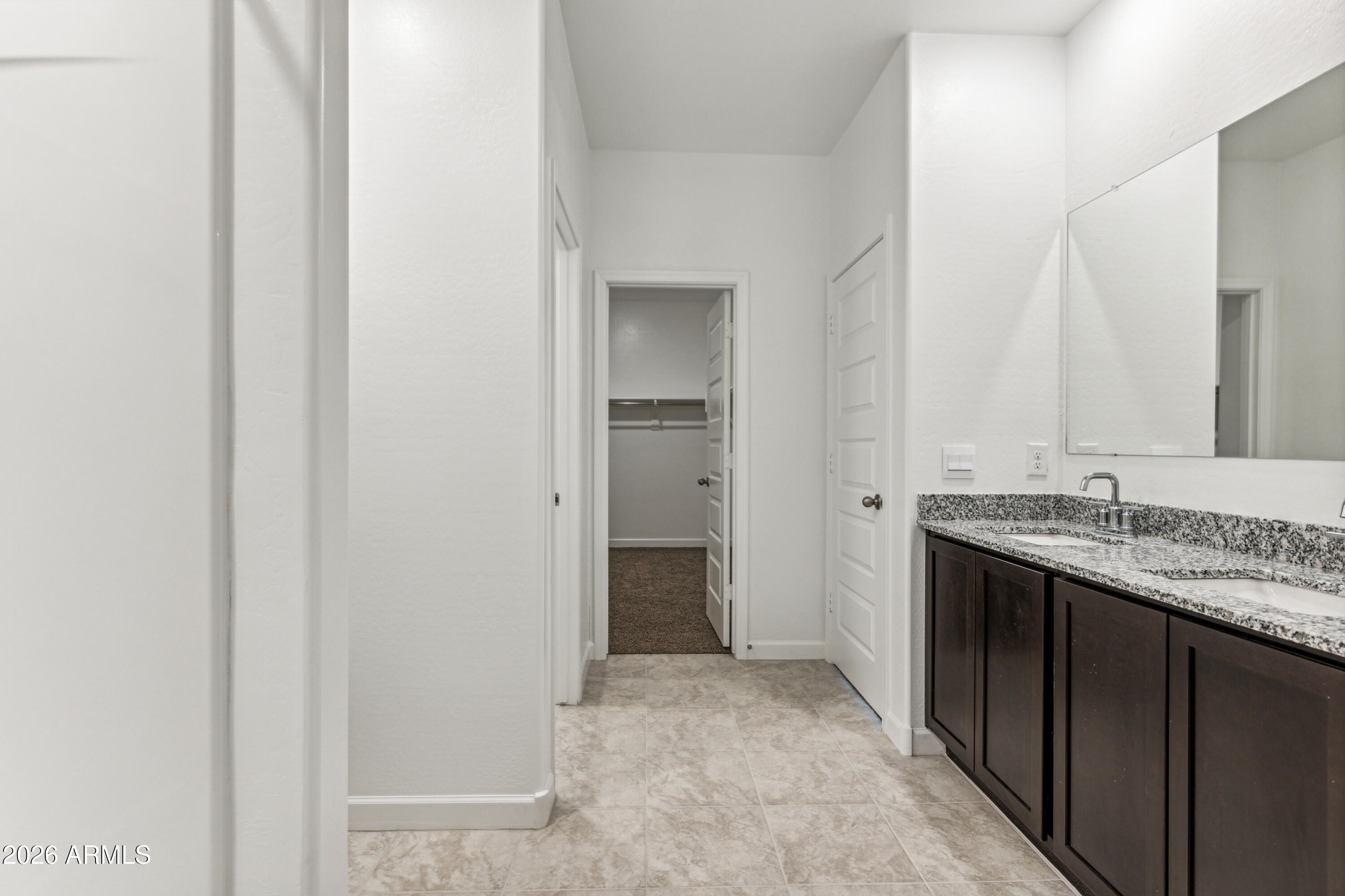 17885 North Ravello Road Maricopa, AZ 85138 - Photo 16 of 35 a bathroom with a granite countertop sink and a mirror
