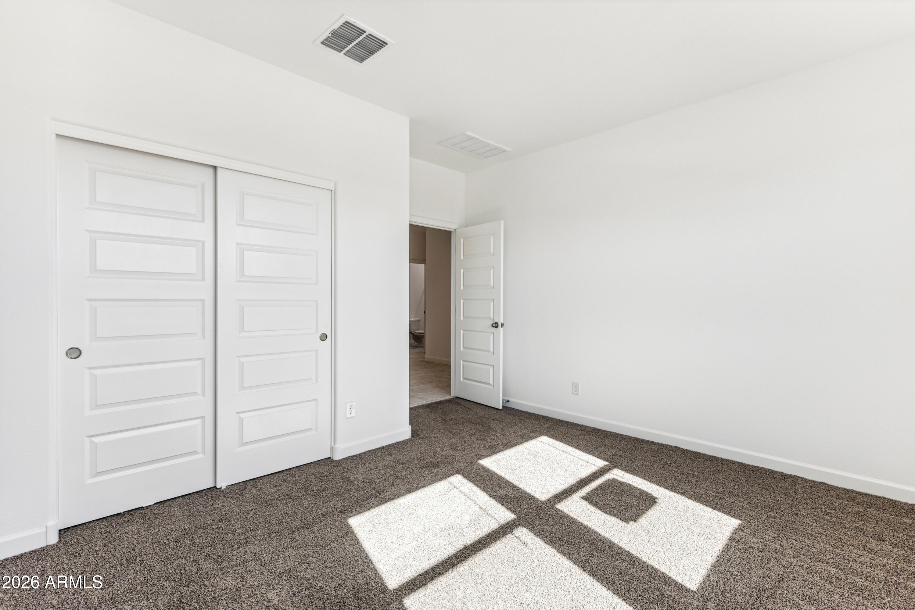17885 North Ravello Road Maricopa, AZ 85138 - Photo 18 of 35 an empty room with windows