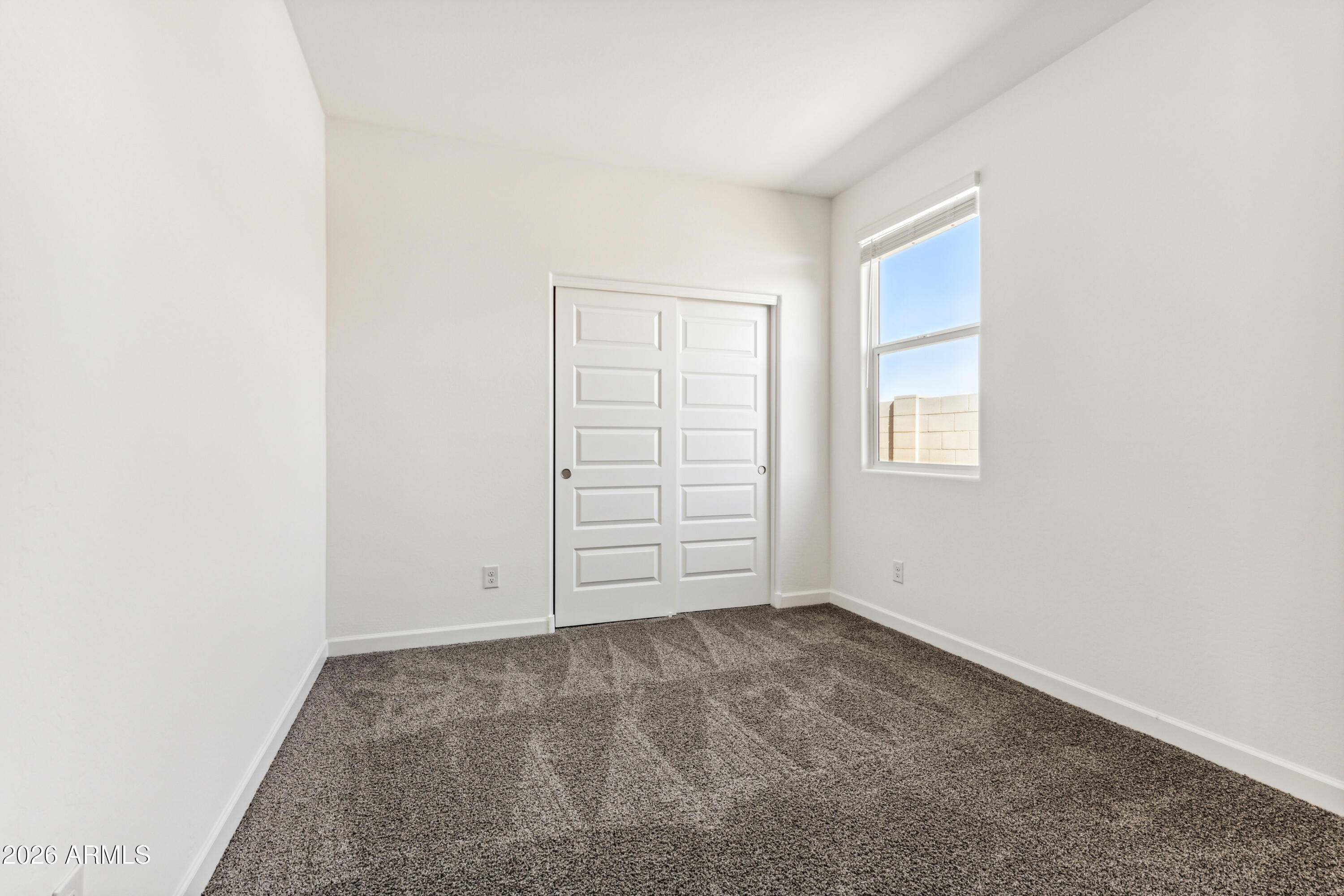 17885 North Ravello Road Maricopa, AZ 85138 - Photo 22 of 35 an empty room with windows