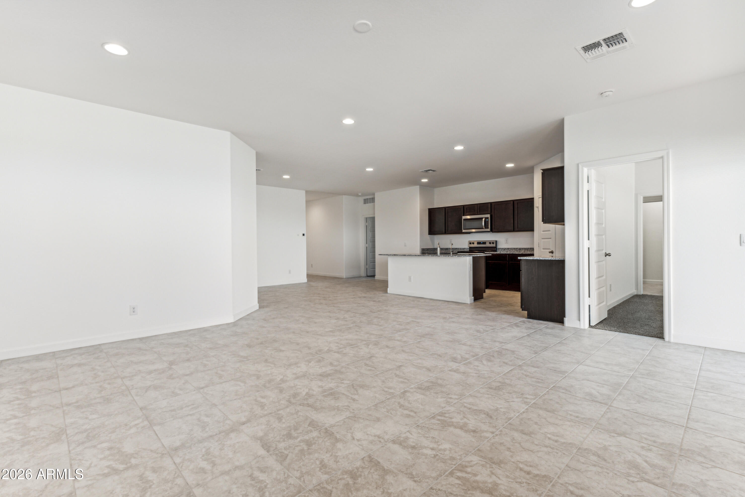 17885 North Ravello Road Maricopa, AZ 85138 - Photo 4 of 35 a view of kitchen with stainless steel appliances refrigerator oven and cabinets