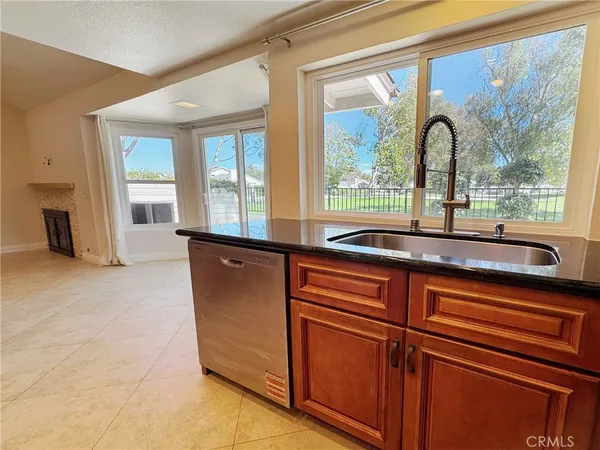 an empty room with wooden floor mirror and windows