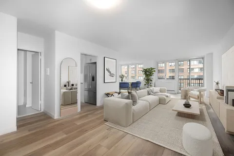 a living room with furniture white walls and white walls