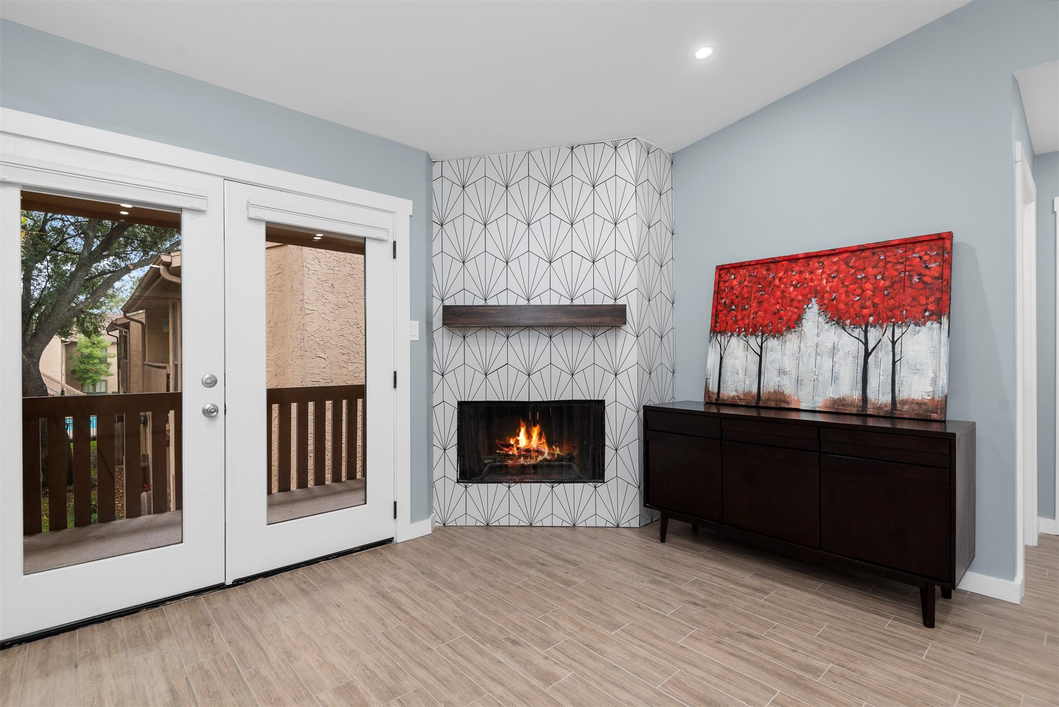 5000 Milwee Street, Unit 54 Houston, TX 77092 - Photo 7 of 25 A redesigned fireplace surrounded by warmth — this space invites you to settle in and stay a while.