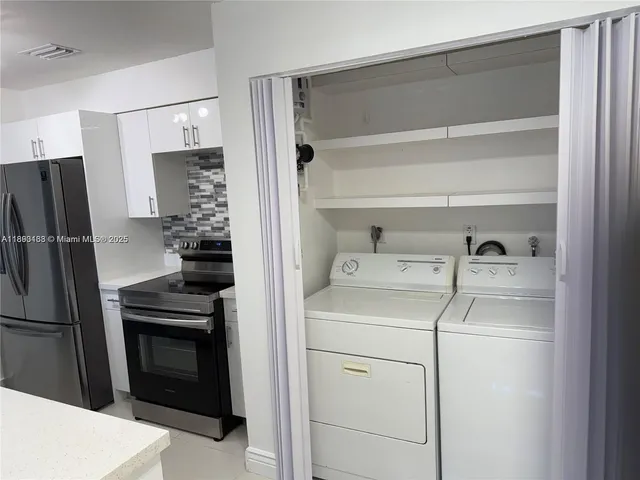 a kitchen with a refrigerator and a stove