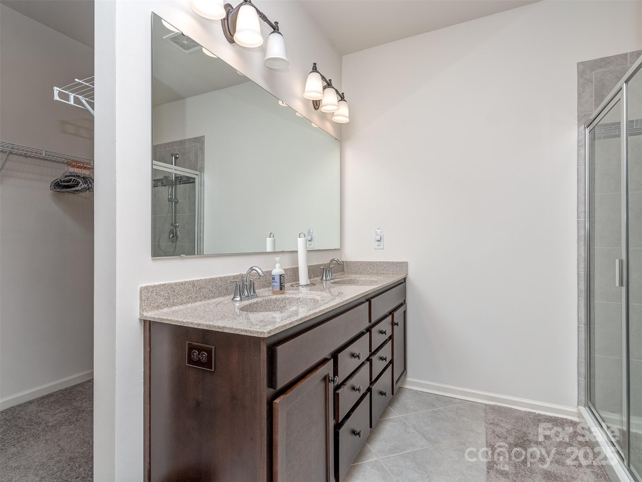 5220 Admirals Landing Lancaster, SC 29720 - Photo 20 of 48 a bathroom with a granite countertop sink a large mirror and a shower