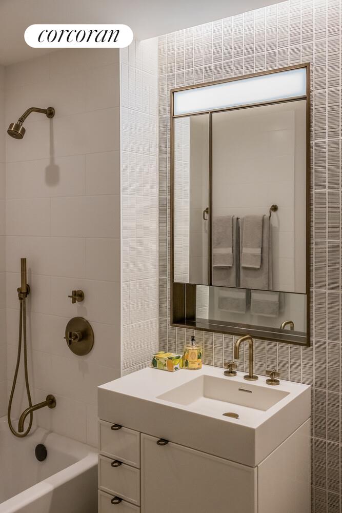 39 West 23rd Street, Unit PH20 Manhattan, NY 10010 - Photo 12 of 15 a bathroom with a double vanity sink a mirror and a shower