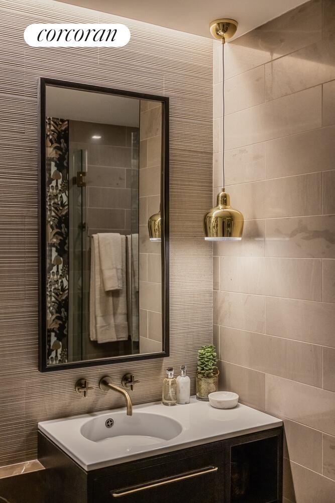 39 West 23rd Street, Unit PH20 Manhattan, NY 10010 - Photo 6 of 15 a bathroom with a sink and a mirror